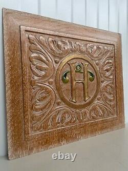 A Stunning Carved Panel in oak with the letter H