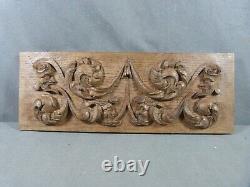 Renaissance-style carved oak bas-relief decorated with 4 grotesque heads